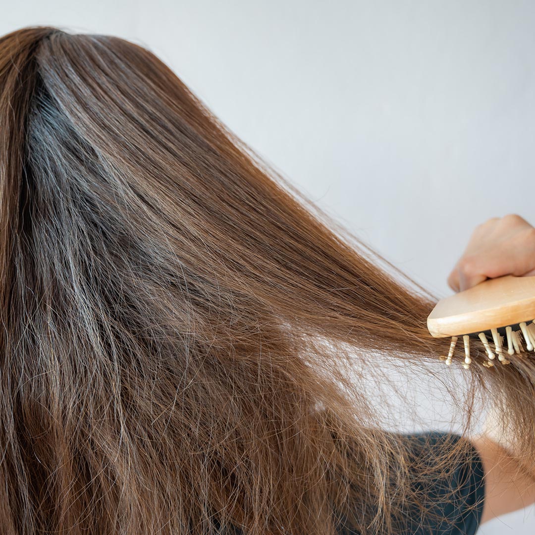 frizzy hair being brushed